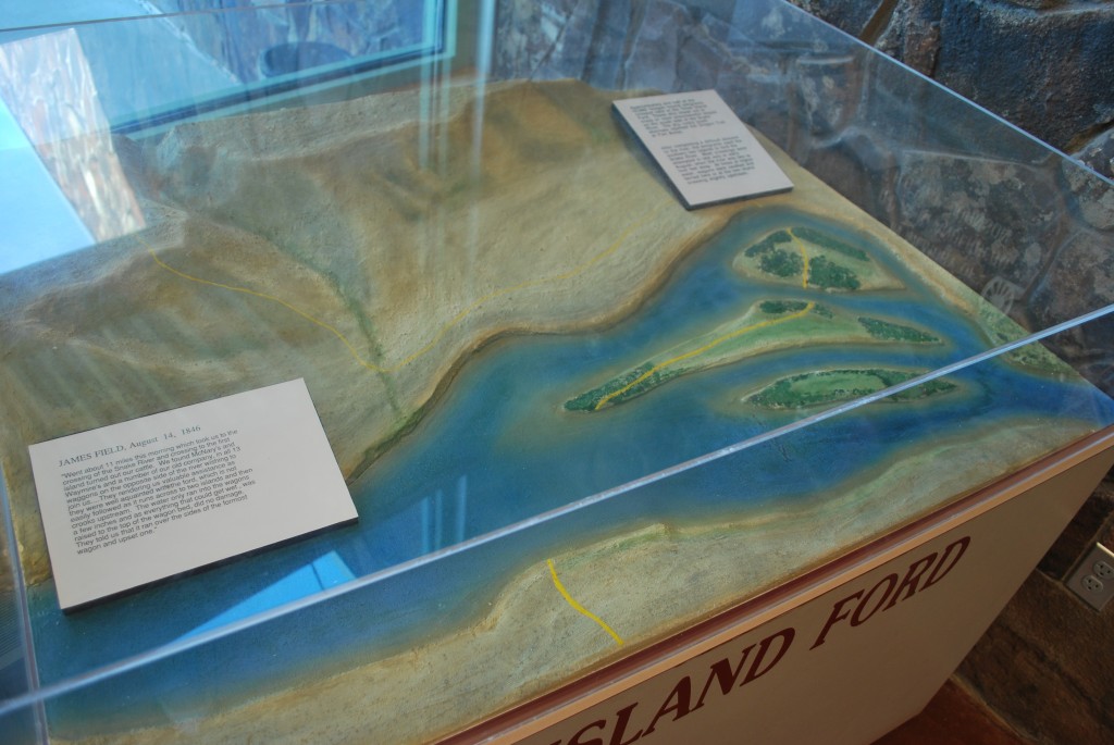 A display showing an aerial view of Three Island Crossing
